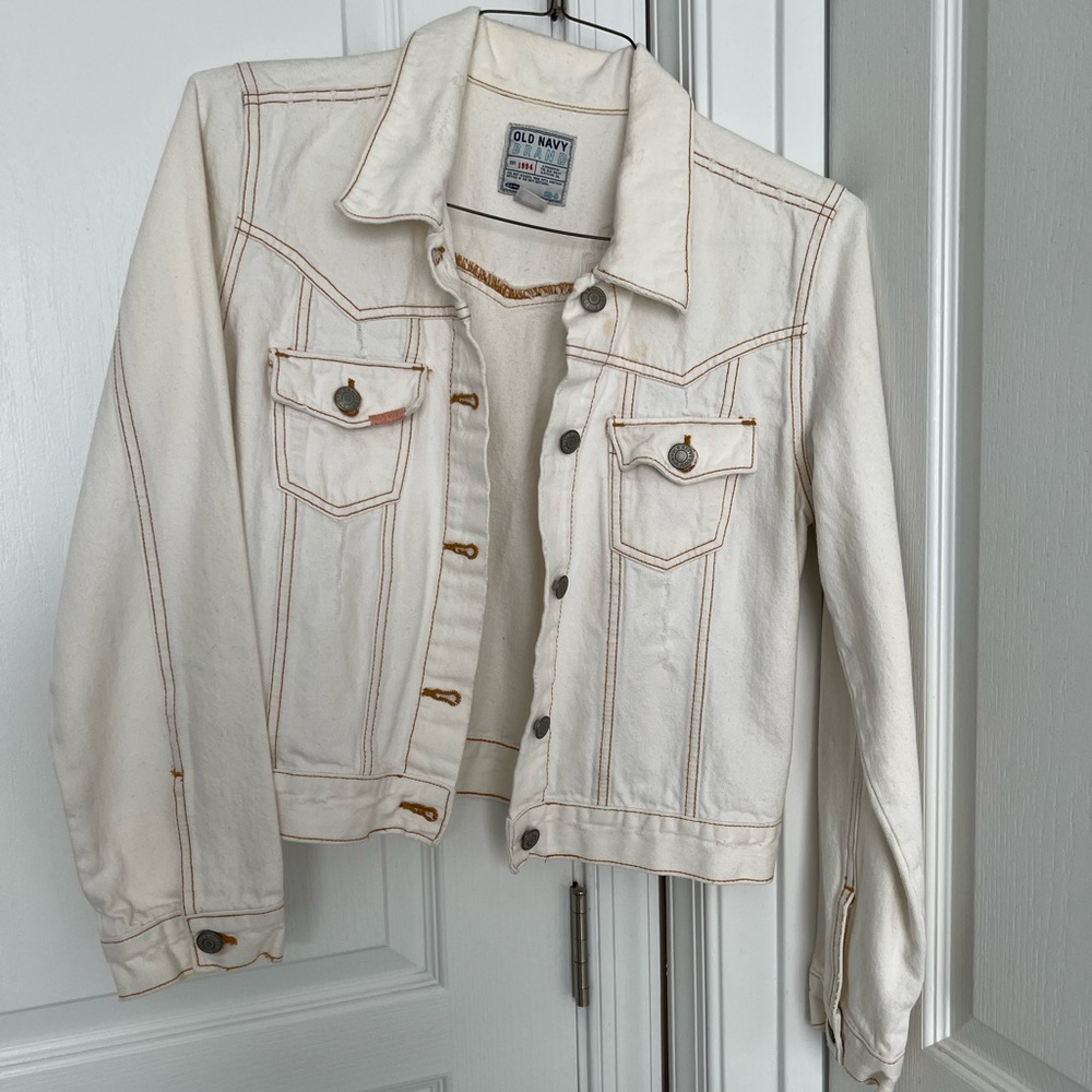 White denim jacket with embellished back.